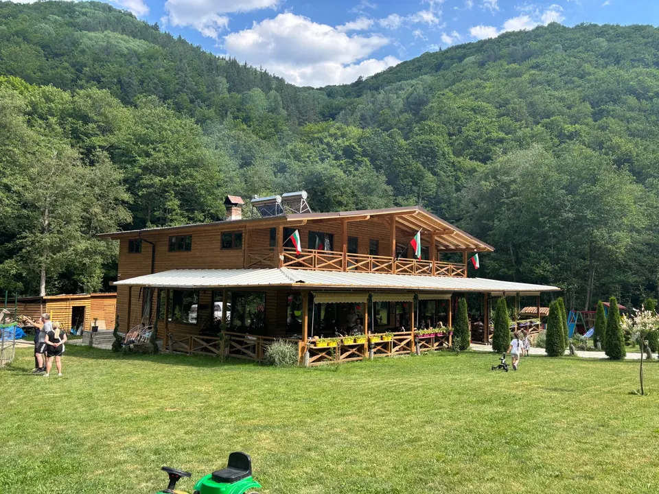 Hristiana restaurant exterior, lawn and forested valley.