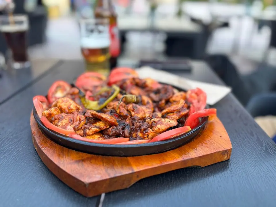 Food served on a sizzling platter at Vision.