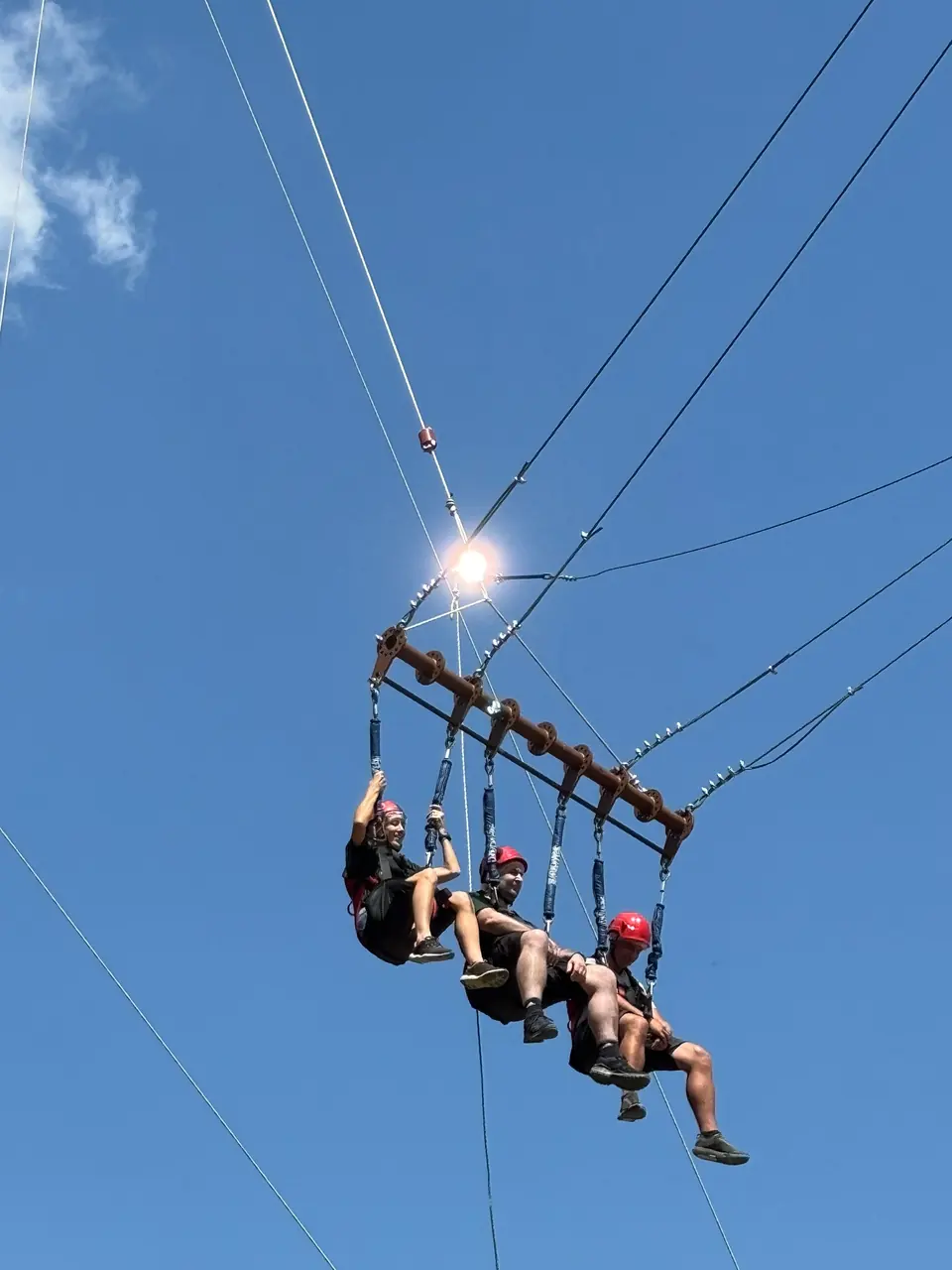 Three people on the Rila Swing at Rila Fun Park.