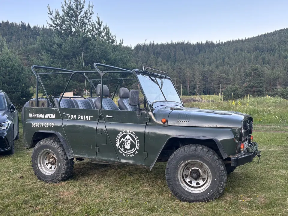 Off-road jeep in a mountain clearing.