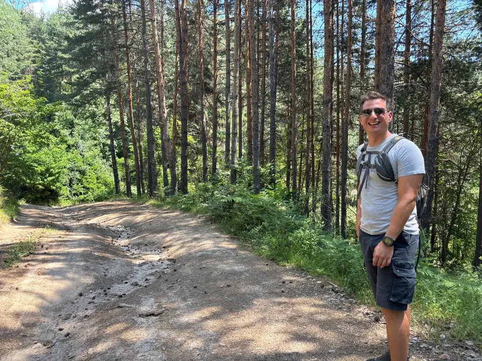 A walker on the stony forest road along the Bear Park outing.
